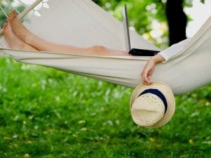Personal relaxing with laptop in a hammock